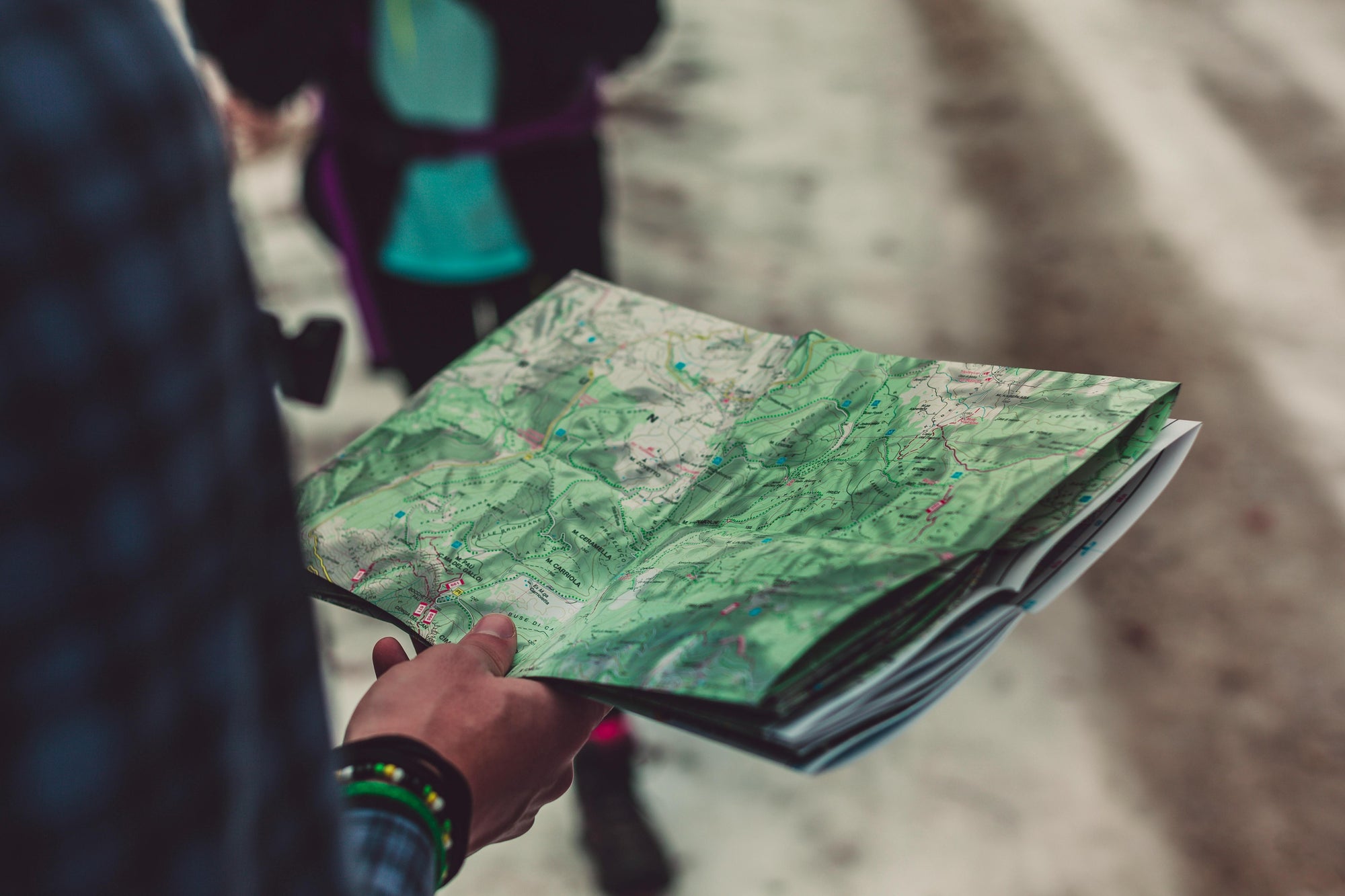 Person holding an open map outdoors — symbolizing Brainchild’s approach to strategic navigation, exploration, and finding the right path forward.